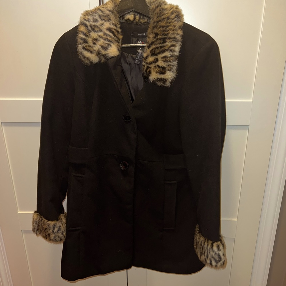 Black mid length coat with fur collar and cuffs.